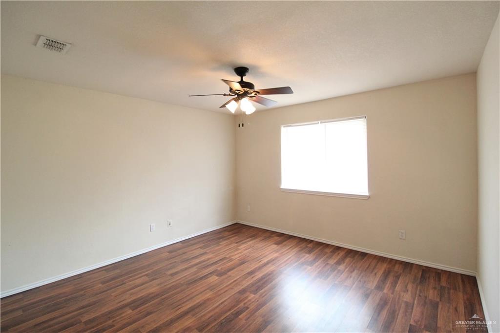8202 North 22nd Lane McAllen, TX 78504 - Photo 17 of 25 wooden floor in an empty room with a window