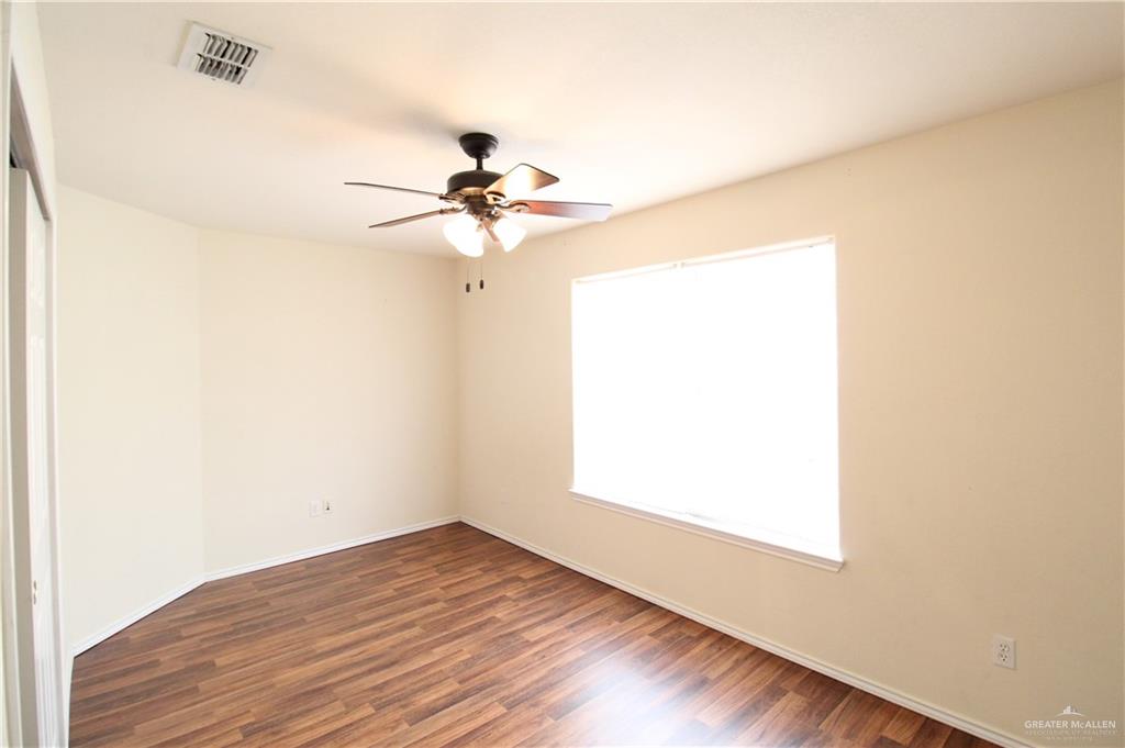 8202 North 22nd Lane McAllen, TX 78504 - Photo 20 of 25 a view of an empty room with wooden floor and a window