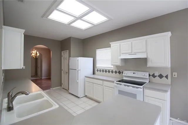 a kitchen with appliances cabinets and a counter top space