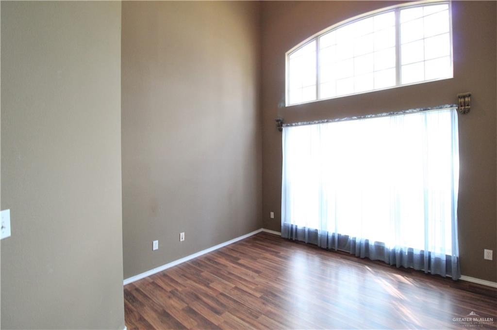 8202 North 22nd Lane McAllen, TX 78504 - Photo 10 of 25 an empty room with wooden floor and windows