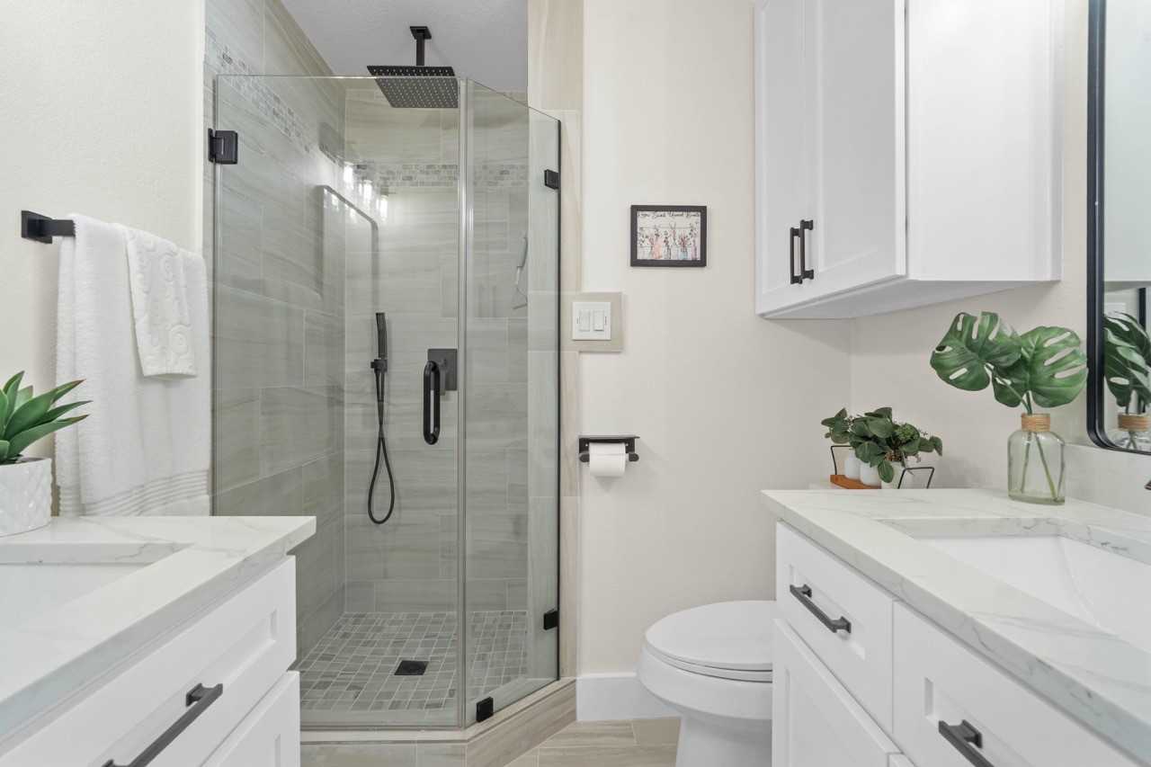 3138 Sunbeam Street Houston, TX 77051 - Photo 31 of 50 Indulge in spa-like luxury with dual vanities, designer finishes, and a stunning frameless glass walk-in shower as part of the primary ensuite bath.