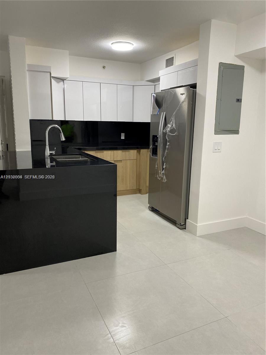 15480 Southwest 284th Street, Unit 2203 Homestead, FL 33033 - Photo 2 of 13 a kitchen with a refrigerator and a counter top