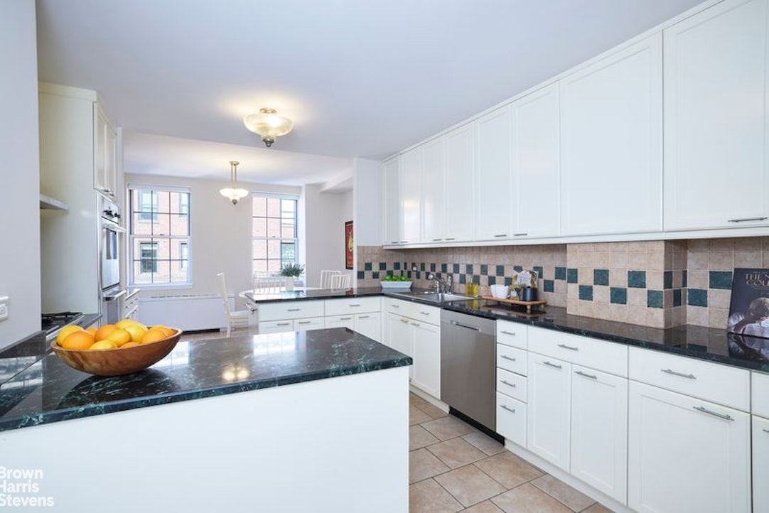 841 Madison Avenue, Unit 11/12 Manhattan, NY 10021 - Photo 12 of 19 a kitchen with stainless steel appliances granite countertop a sink a stove and cabinets