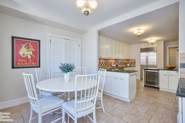 a kitchen with stainless steel appliances granite countertop a sink a stove and cabinets