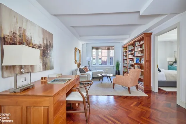 a bedroom with a bed and a chair