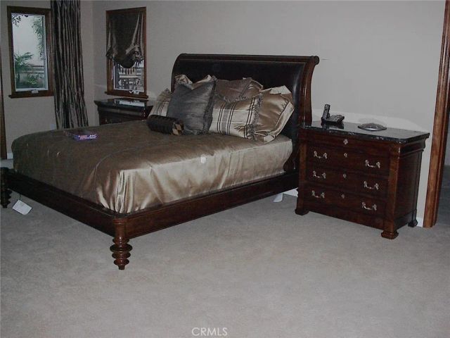 a bedroom with a bed and a night stand