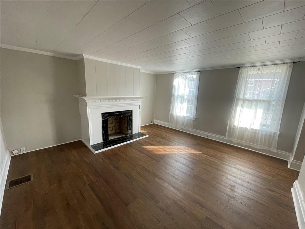 624 4th Street Monongahela, PA 15063 - Photo 14 of 29 an empty room with wooden floor and fireplace