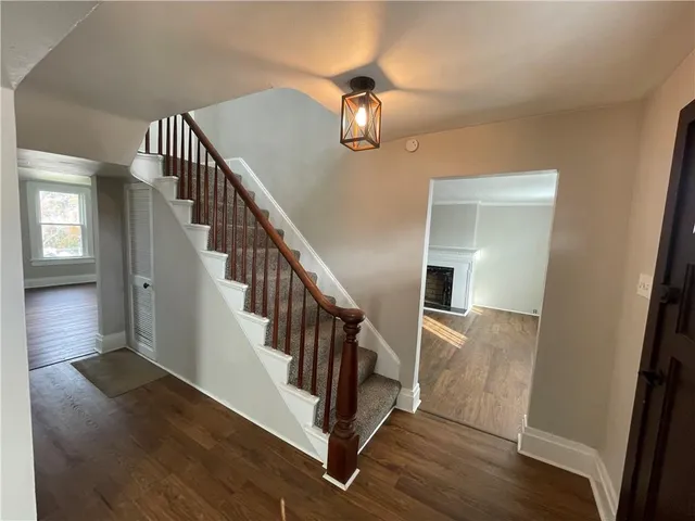 a view of entryway and hall with wooden floor