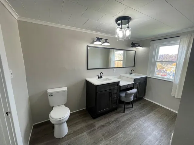a spacious bathroom with a toilet sink and mirror