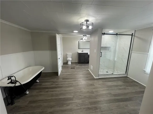 a view of a room with furniture and wooden floor