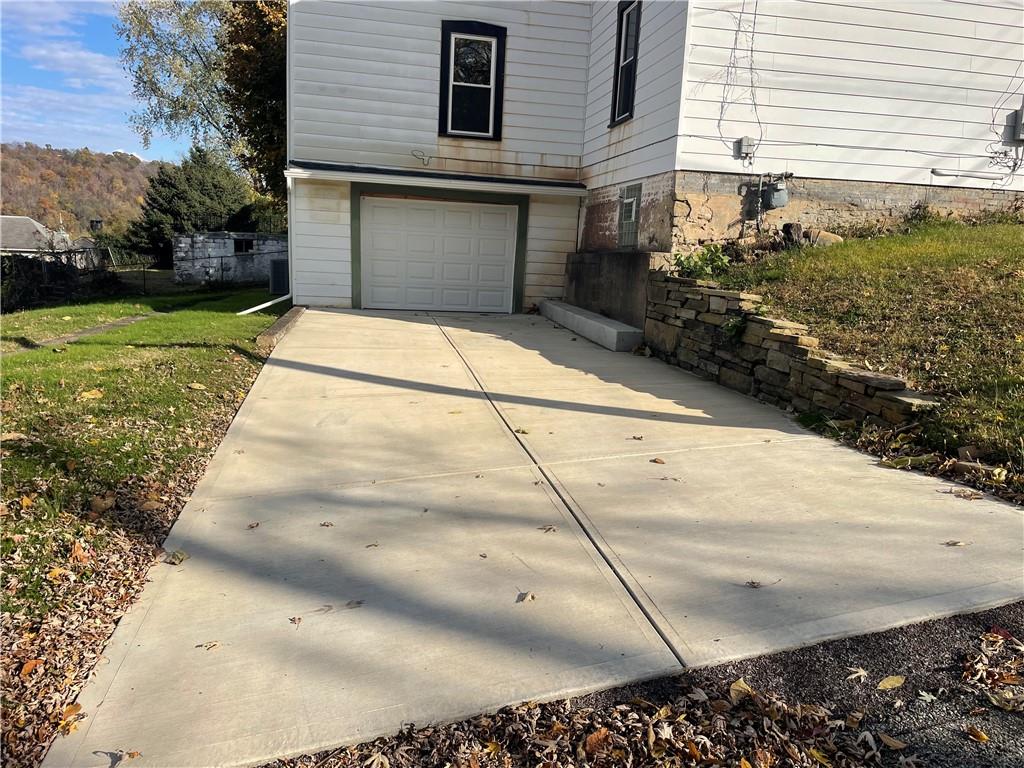 624 4th Street Monongahela, PA 15063 - Photo 4 of 29 a front view of a house with a yard and garage