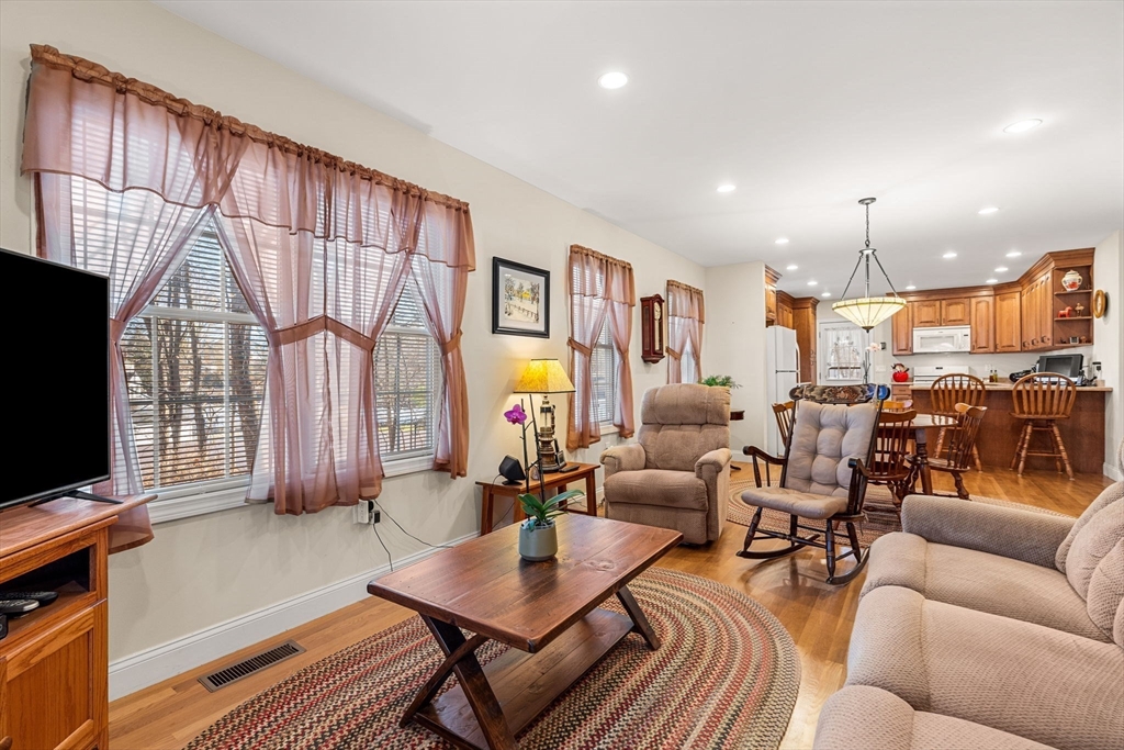 28 Van Norden Road Woburn, MA 01801 - Photo 12 of 24 a living room with furniture a flat screen tv and a large window