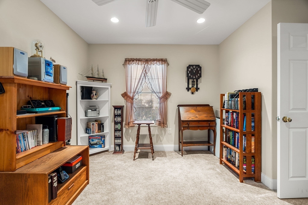 28 Van Norden Road Woburn, MA 01801 - Photo 16 of 24 a living room with furniture and a book shelf