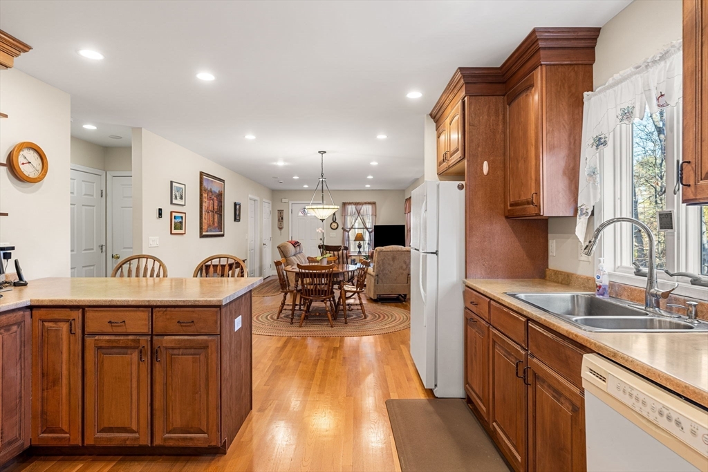 28 Van Norden Road Woburn, MA 01801 - Photo 9 of 24 a kitchen with stainless steel appliances granite countertop a sink and wooden cabinets
