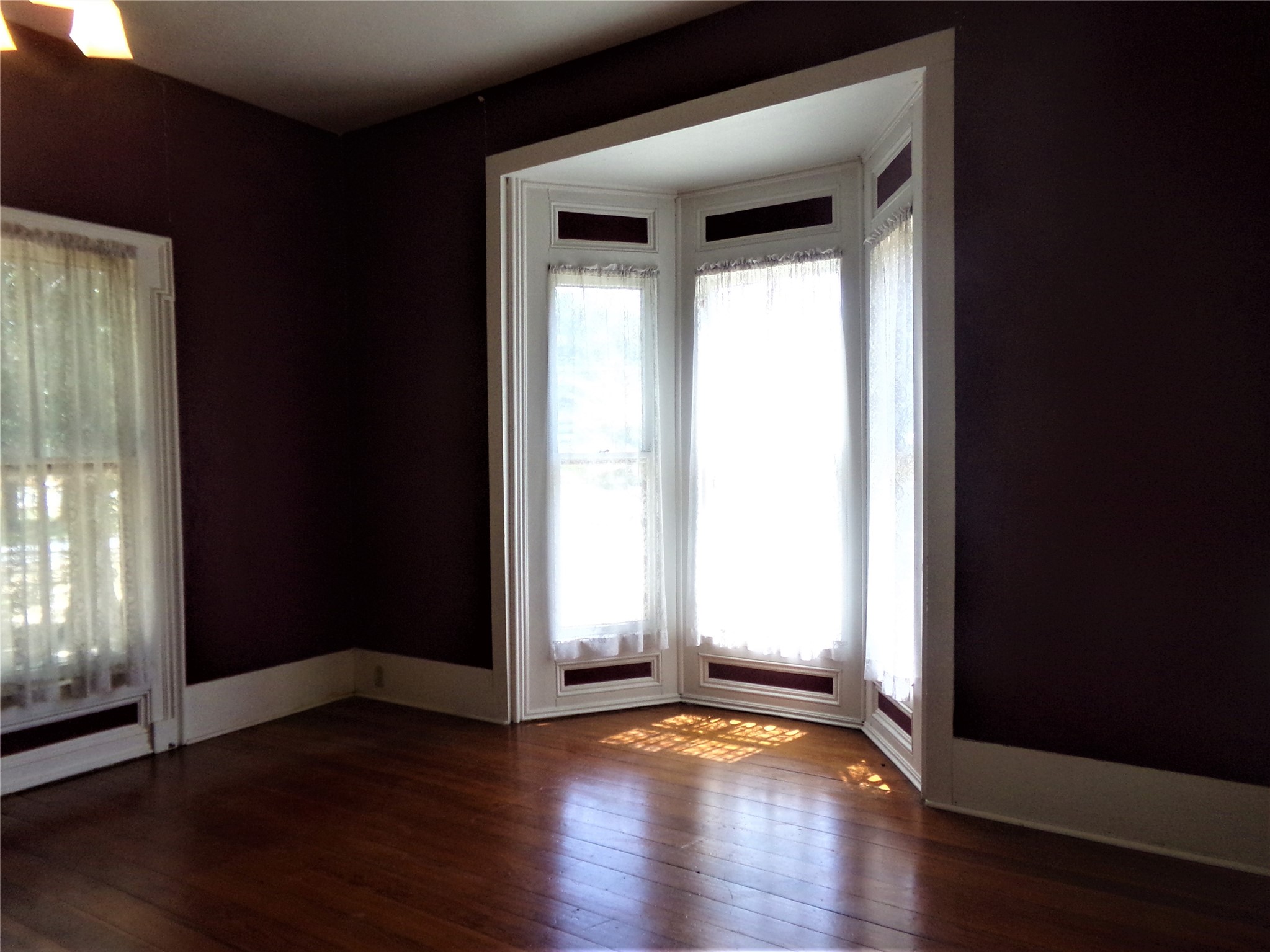 300 South Summit Street Weimar, TX 78962 - Photo 13 of 27 an empty room with wooden floor and windows