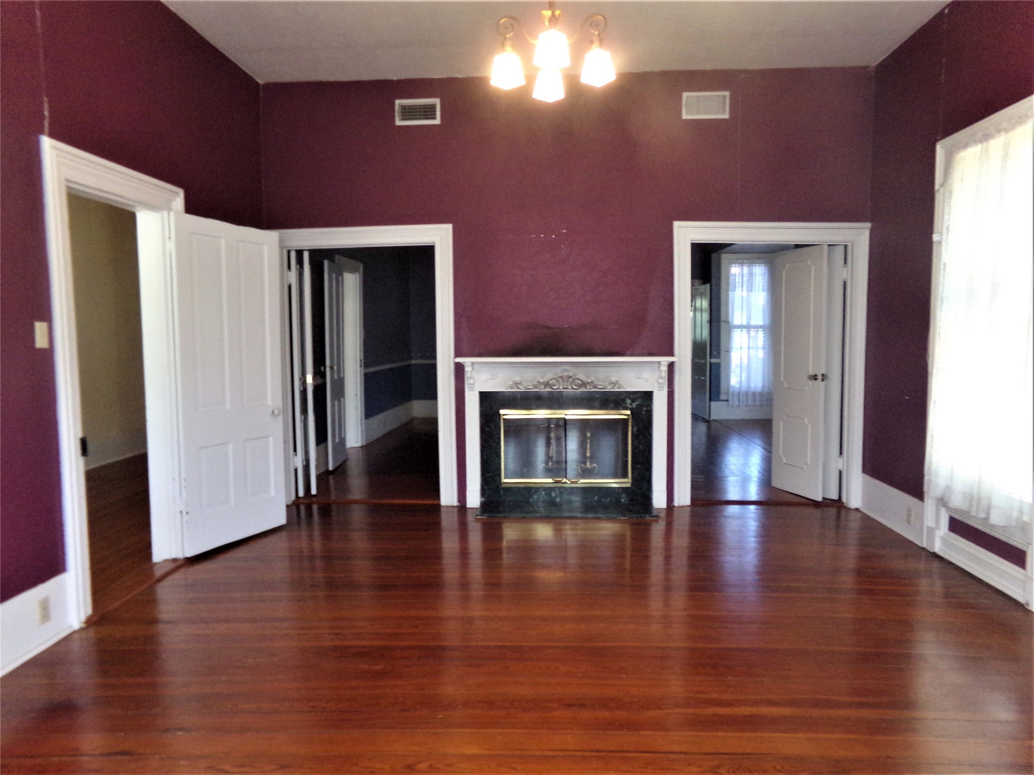 300 South Summit Street Weimar, TX 78962 - Photo 14 of 27 a view of a livingroom with wooden floor and a fireplace