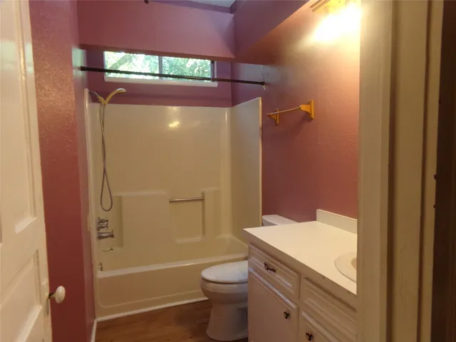 a bathroom with a granite countertop toilet a sink and bathtub