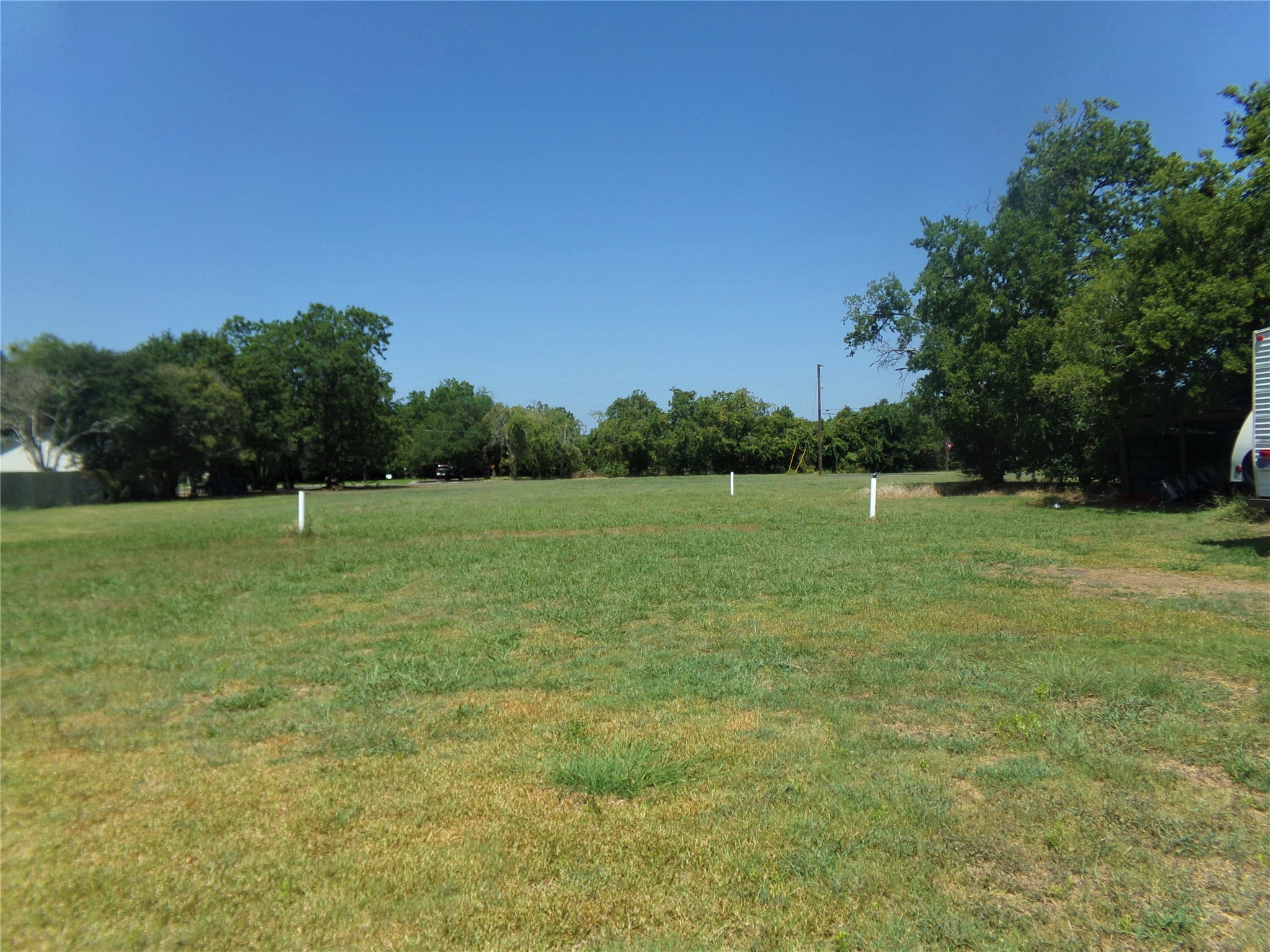 300 South Summit Street Weimar, TX 78962 - Photo 2 of 27 a view of a green field with wooden fence