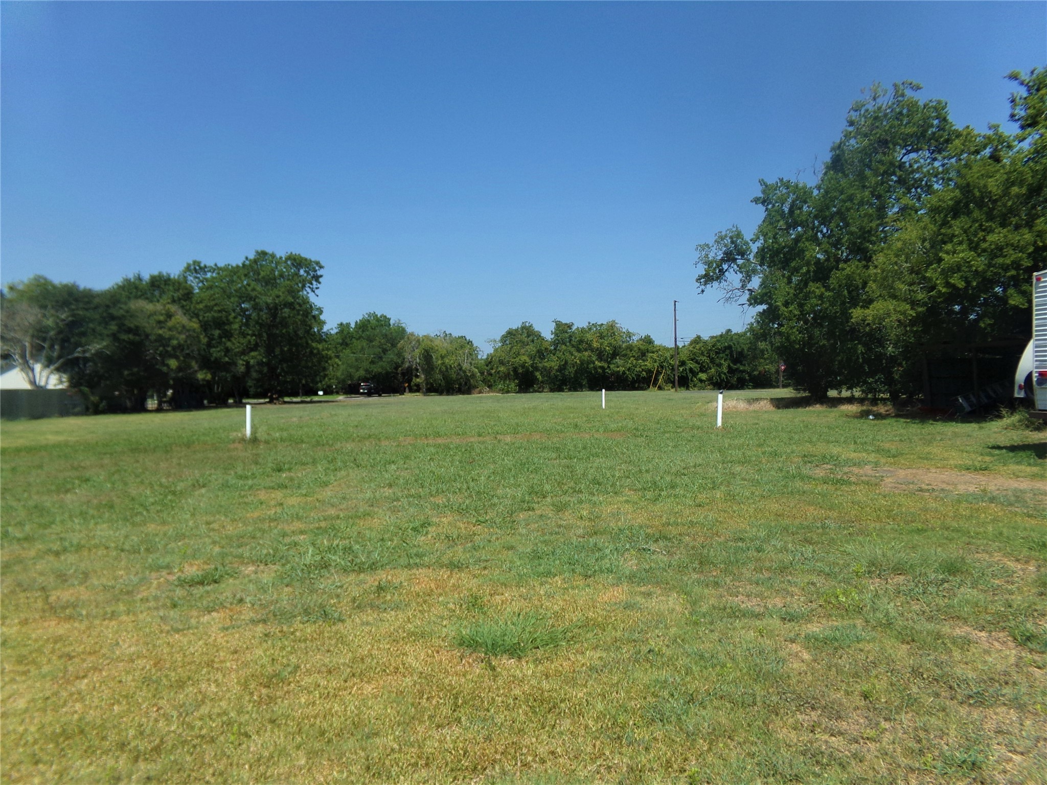 300 South Summit Street Weimar, TX 78962 - Photo 2 of 27 a view of a green field with wooden fence