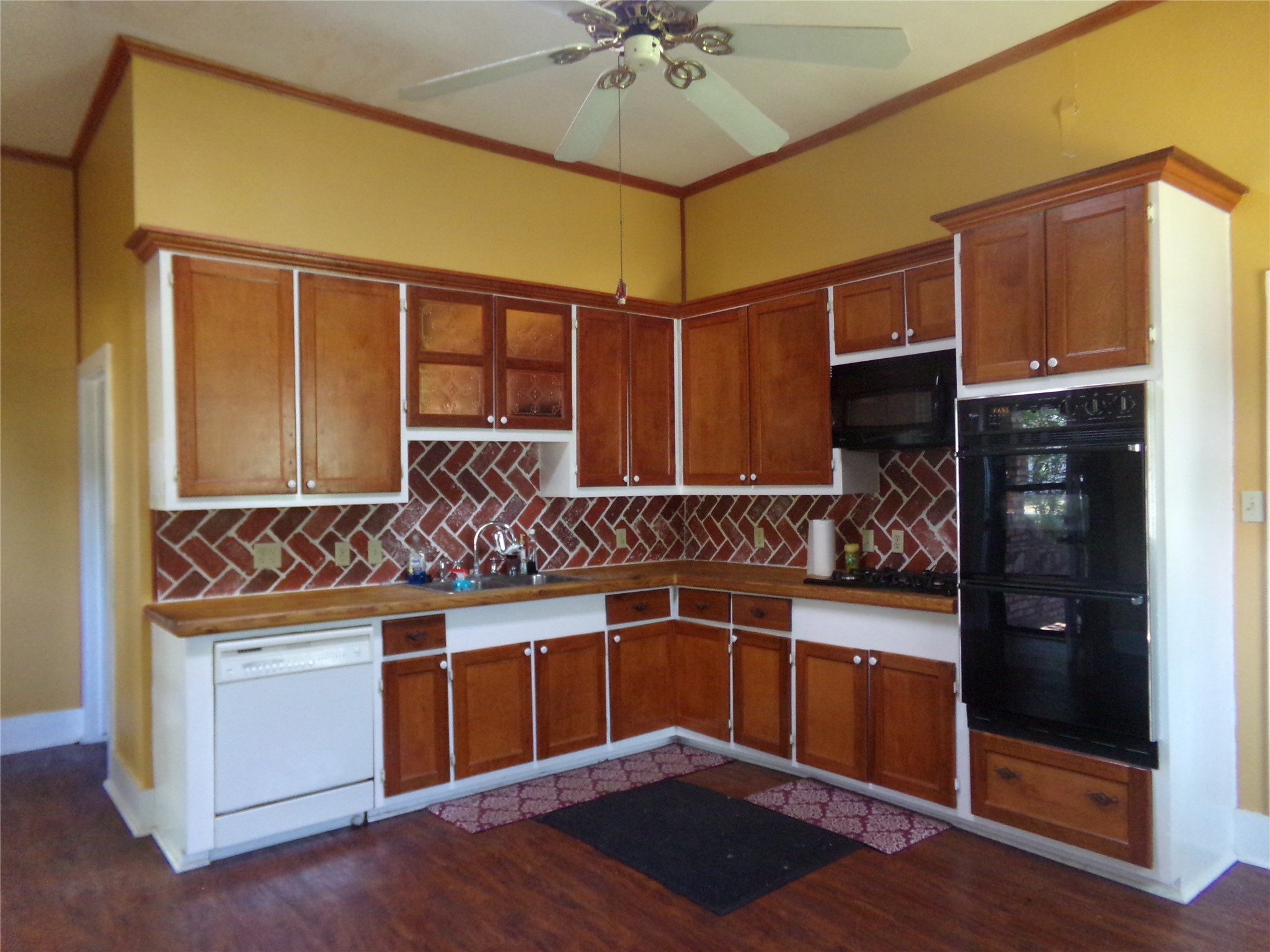300 South Summit Street Weimar, TX 78962 - Photo 6 of 27 a kitchen with stainless steel appliances a stove and a refrigerator