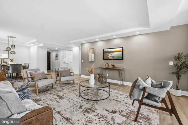 a dining room with furniture wooden floor a rug and a painting