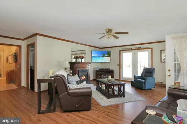 a living room with furniture a fireplace and a large window