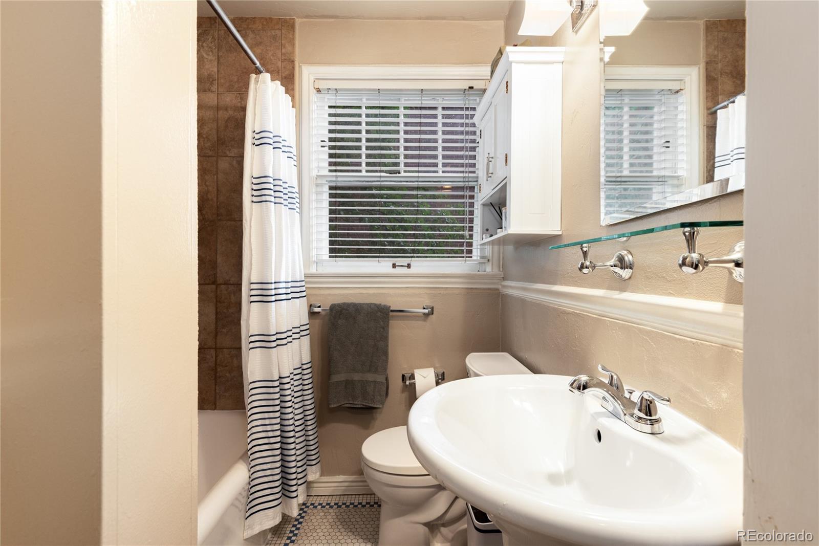 931 Emerson Street, Unit 1 Denver, CO 80218 - Photo 16 of 22 a bathroom with a sink a toilet and shower