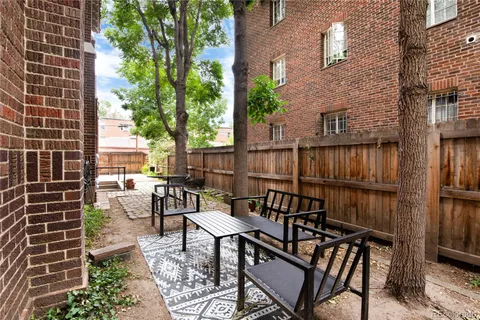 a view of balcony with wooden floor and outdoor seating