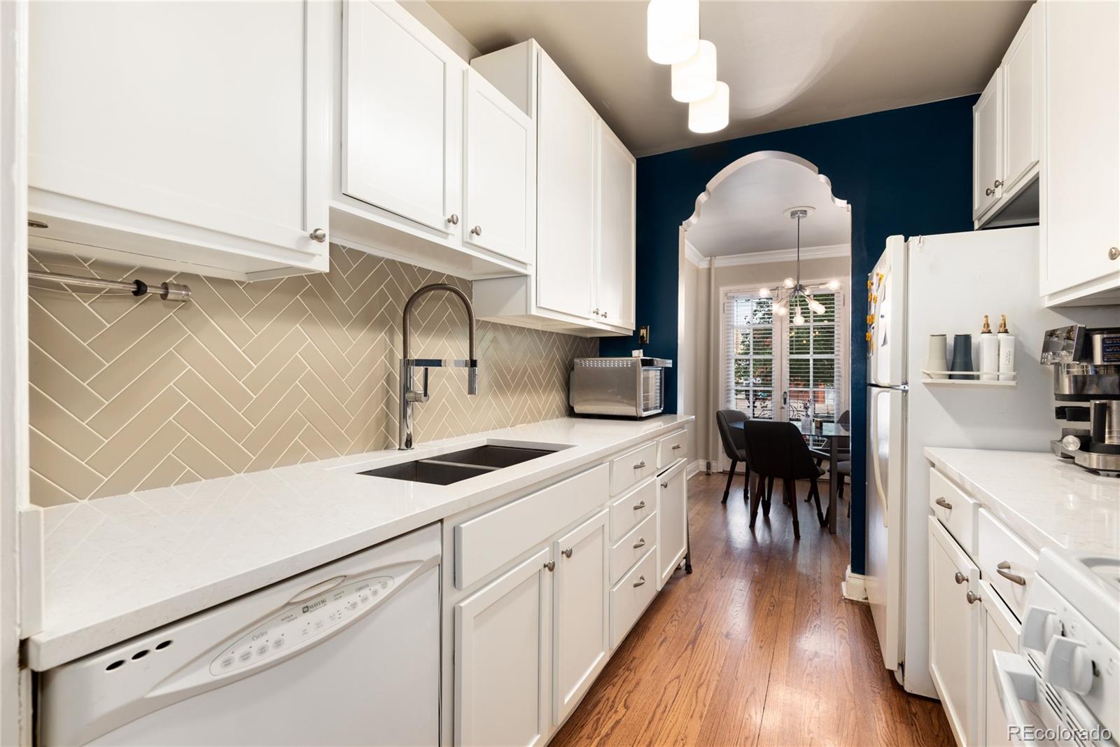 931 Emerson Street, Unit 1 Denver, CO 80218 - Photo 4 of 22 a kitchen with cabinets a sink appliances and a counter space