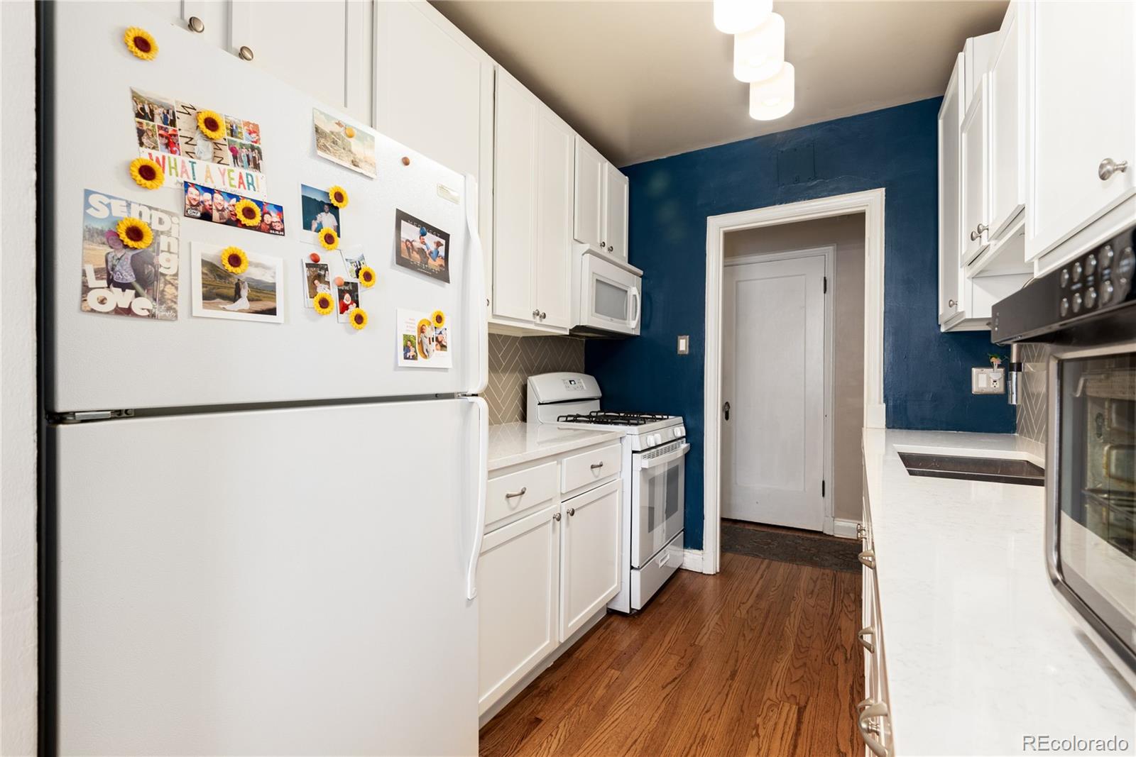 931 Emerson Street, Unit 1 Denver, CO 80218 - Photo 7 of 22 a white refrigerator freezer sitting inside of a kitchen