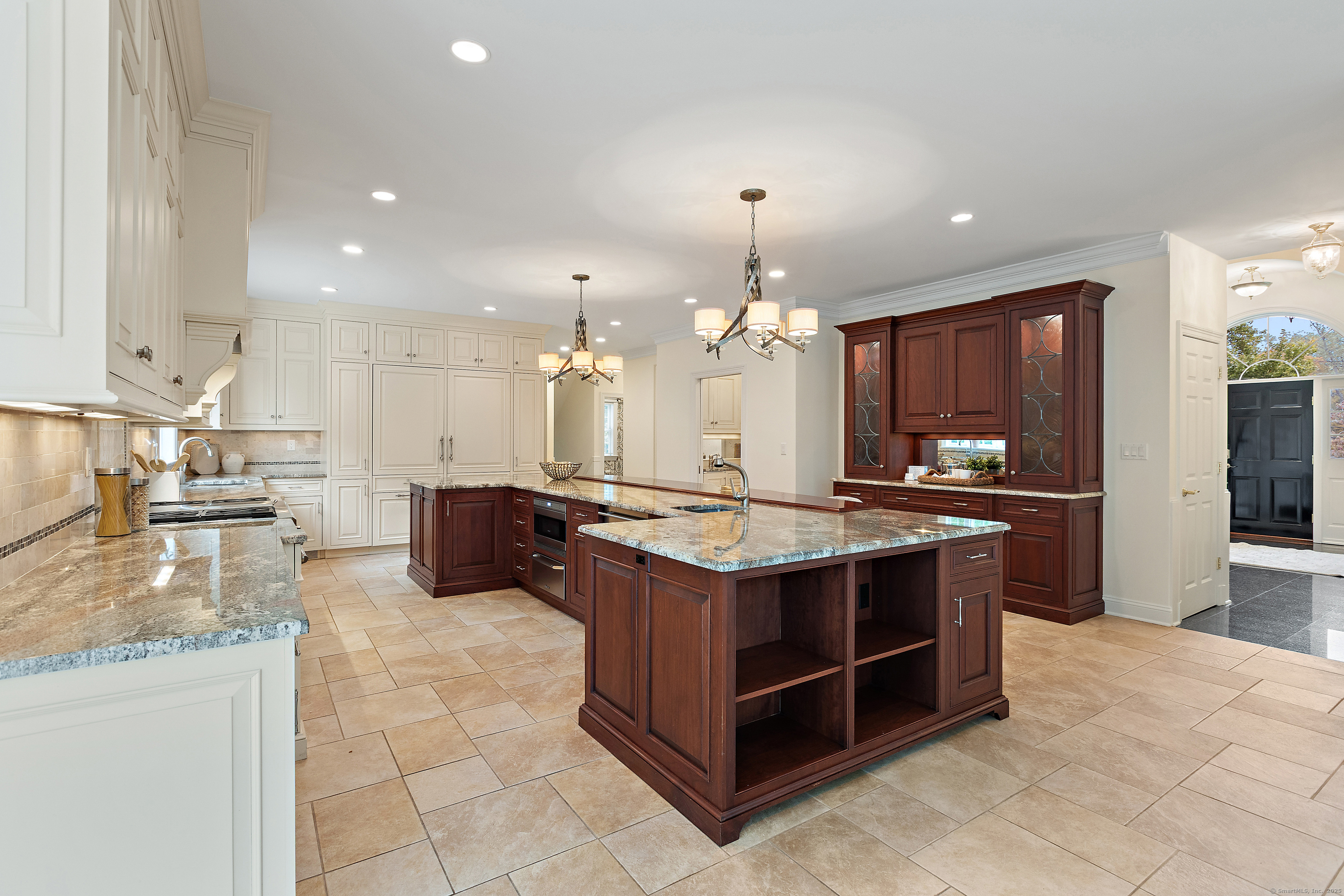 113 Skyview Lane New Canaan, CT 06840 - Photo 11 of 40 a large kitchen with kitchen island a island a stove a sink a counter space and cabinets