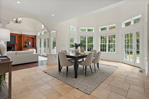 a view of a dining room with furniture and a large window