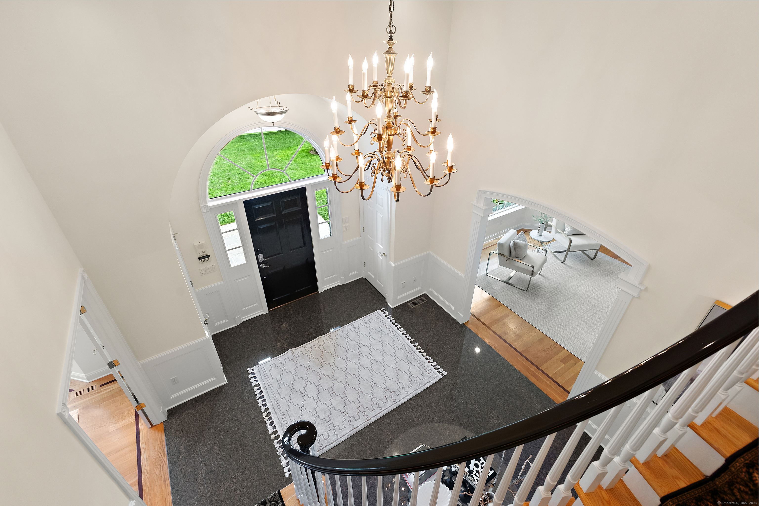 113 Skyview Lane New Canaan, CT 06840 - Photo 18 of 40 a view of a dining room with furniture and a chandelier