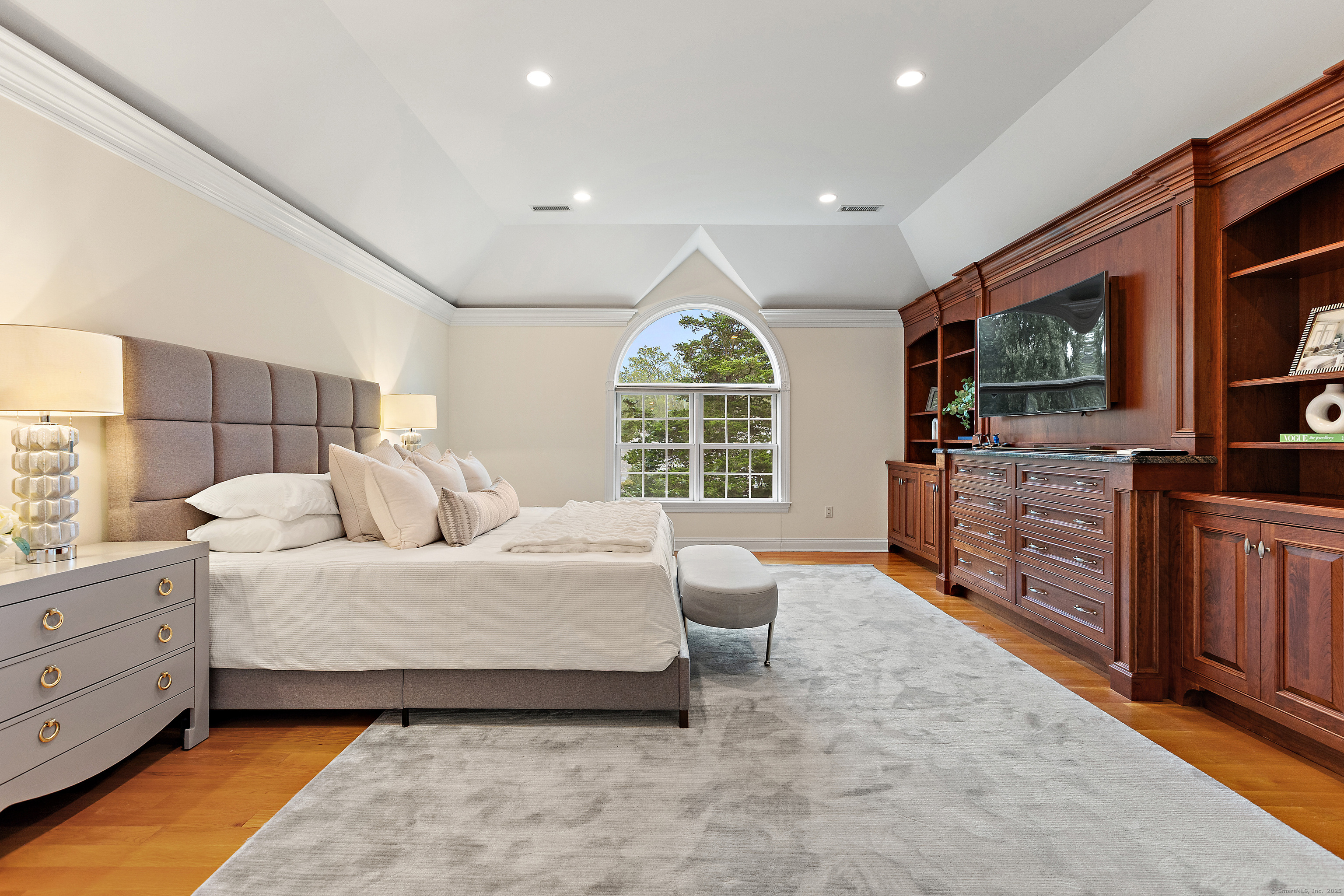 113 Skyview Lane New Canaan, CT 06840 - Photo 19 of 40 a spacious bedroom with a bed and furniture
