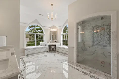 a spacious bathroom with a shower a sink and a mirror