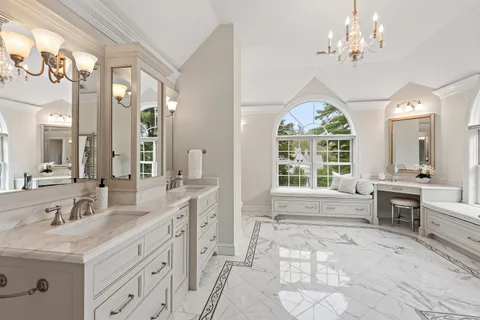 a spacious bathroom with a double vanity sink a large mirror and a bathtub