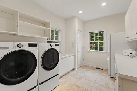 a utility room with sink dryer and washer