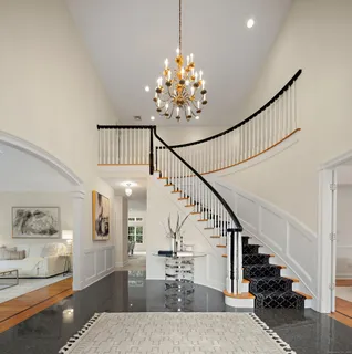a view of entryway and hall with wooden floor