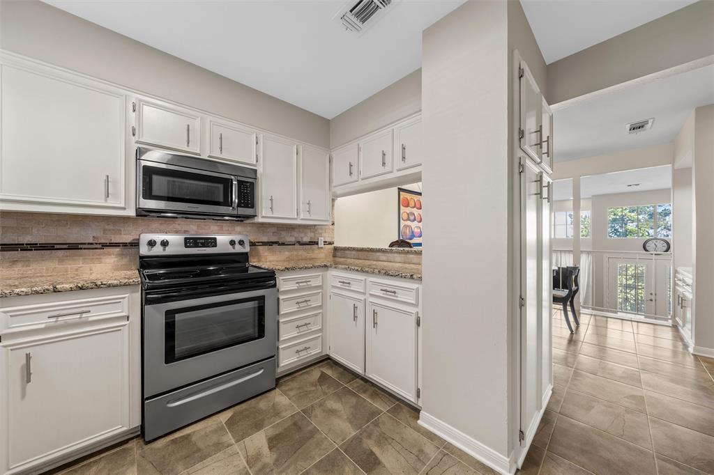 2901 Lake Shore Drive, Unit 405 Waco, TX 76708 - Photo 13 of 31 a kitchen with granite countertop a stove and a sink