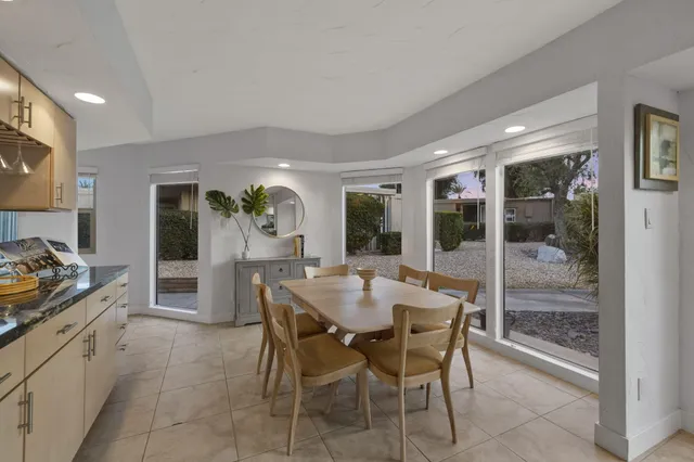 a dining room with furniture and window