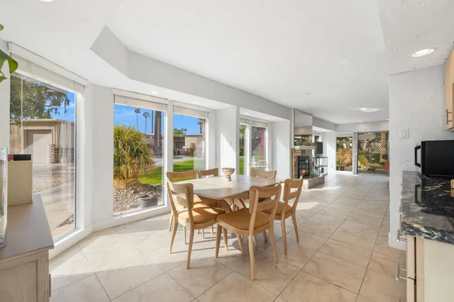 a view of a dining room with furniture window and outside view