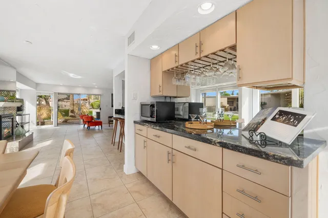 a kitchen with stainless steel appliances granite countertop a sink and cabinets