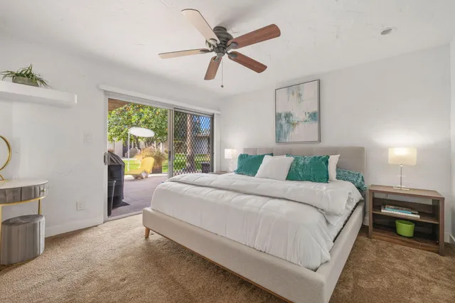a bedroom with a bed and ceiling fan