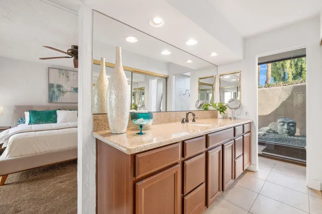 a bathroom with a sink a vanity and mirror
