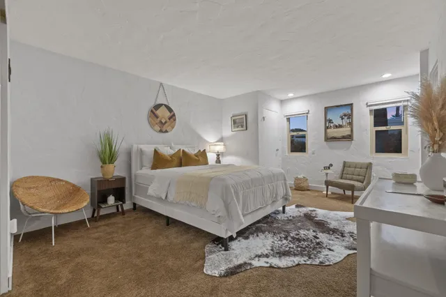 a bedroom with a bed and dresser