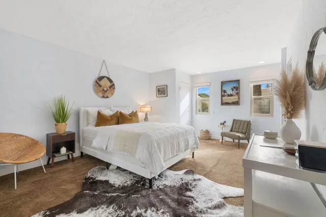 a bedroom with a bed a table and chair