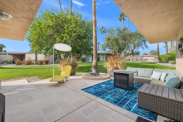 a view of a patio with couches and a table and chairs