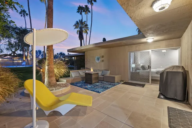 a outdoor space with lots of chairs and plants