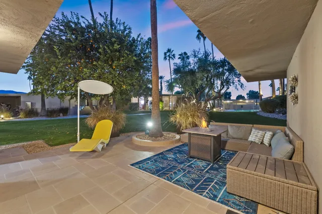 a view of a swimming pool with a patio and a yard