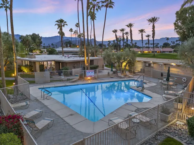 a view of a swimming pool with outdoor seating